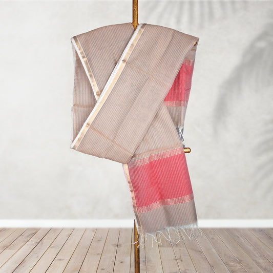 Dupatta with pink and brown pattern on a wooden stand against a white wall.